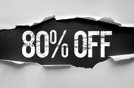 Bold distressed "80% OFF" text revealed through torn paper layers. Eye-catching discount banner or promotion graphic concept perfect for advertising, marketing, sales, or retail campaignsの写真素材