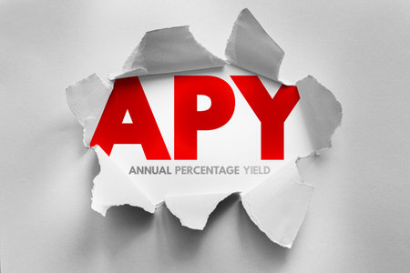 Bold acronym "APY" breaks through torn paper, revealing the term "Annual Percentage Yield" below. A dynamic finance-themed concept image perfect for banking, savings, and investment visualsの写真素材