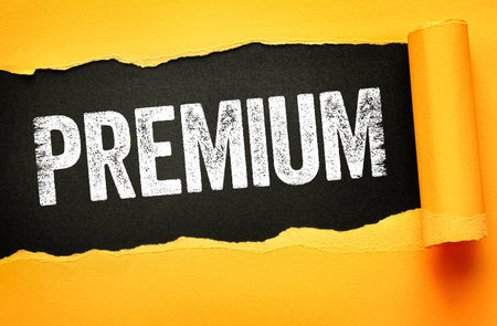 PREMIUM in bold, distressed white lettering revealed through torn yellow paper on a black background. Ideal for marketing, branding, exclusive service promotion, and premium content visualsの写真素材