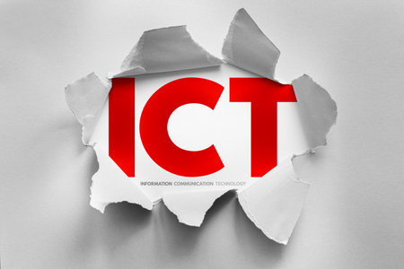 ICT abbreviation for Information Communication Technology exposed through torn paper. Concept for...