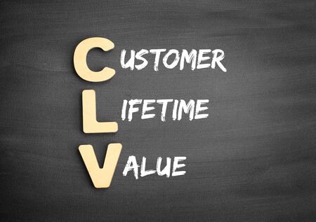 Wooden alphabets building the word CLV - Customer Lifetime Value acronym on blackboardの写真素材