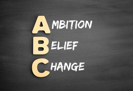 Wooden alphabets building the word ABC - Ambition Belief Change acronym on blackboardの写真素材