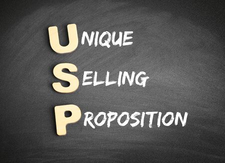 Wooden alphabets building the word USP - Unique Selling Proposition acronym on blackboardの写真素材