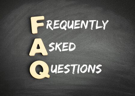 Wooden alphabets building the word FAQ - Frequently Asked Questions acronym on blackboardの写真素材