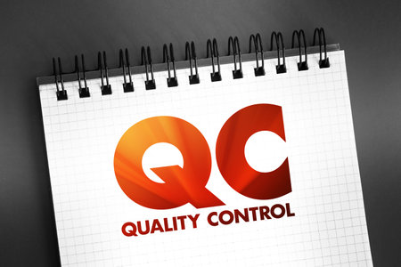 QC Quality Control - process by which entities review the quality of all factors involved in production, acronym text concept on notepadの写真素材