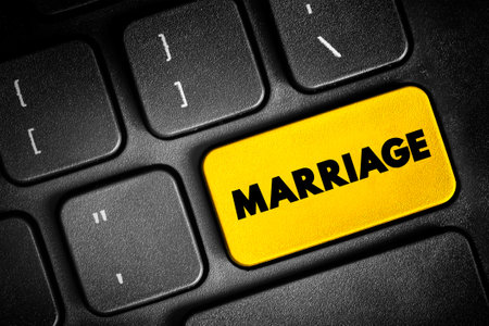 Marriage - the legally or formally recognized union of two people as partners in a personal relationship, text button on keyboard, concept backgroundの写真素材