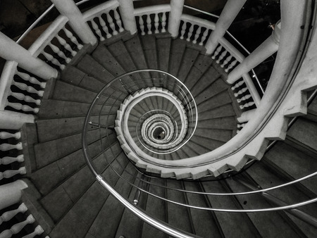 white old circular staircase at the nightの写真素材