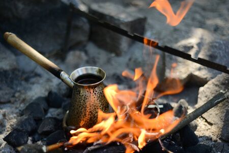 black turkish coffee cooking on the fireの写真素材