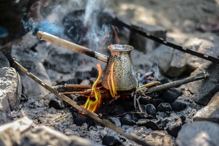 black turkish coffee cooking on the fireの写真素材