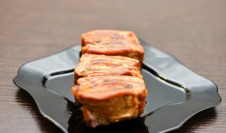 delicious fried ribs on the black plateの写真素材