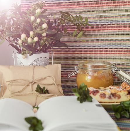 notepad, paper envelope and piece of pie on the colorful tablecloth. sunlightの写真素材
