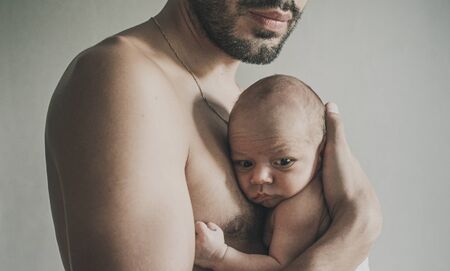 Portrait of loving father with baby at home. Man with baby. Young man holding with little baby. Sepia Tonedの写真素材