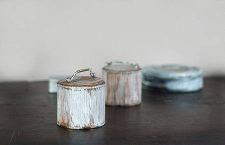 four small old boxes painted white on the wooden tableの写真素材