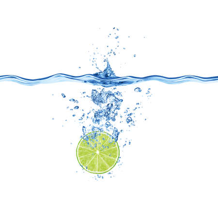 Slice of lime falling in water isolated on white background.