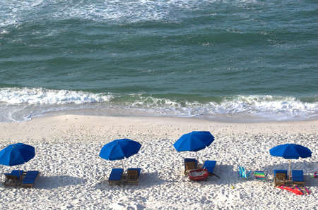 This photo is of beach chairs and umbrellasの写真素材