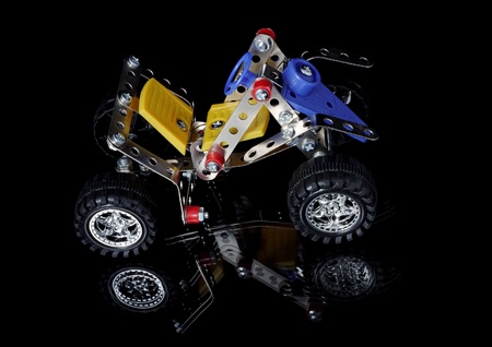 Metal meccano car isolated on blackの写真素材