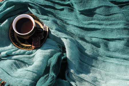 cup of coffee on a fabric greenの写真素材
