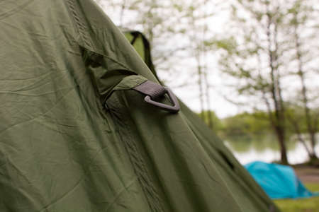 Carbine on a camp tent closeup greenの写真素材