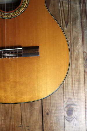 Acoustic guitar on the background of wooden boards