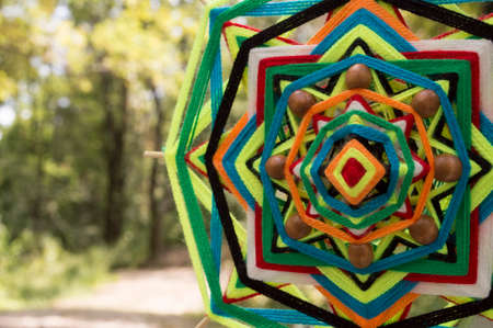Tibetan mandala of colored thread and bamboo sticksの写真素材