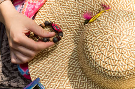 Earrings handmade from polymer clay on the straw hatの写真素材