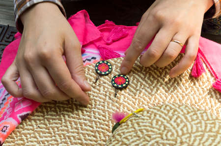 Earrings handmade from polymer clay on the straw hatの写真素材
