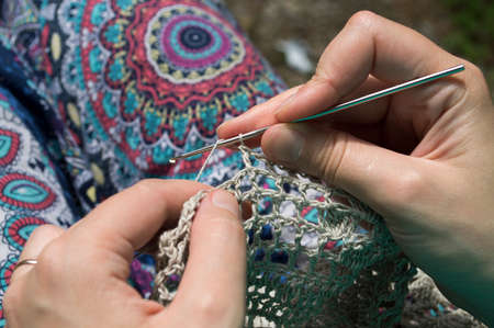 openwork crochet from natural fibers in the wooden backgroundの写真素材