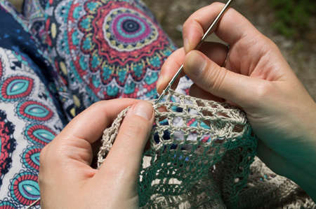 openwork crochet from natural fibers in the wooden backgroundの写真素材