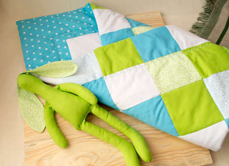 stitched stuffed toys for babies on a wood background