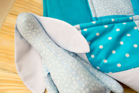 stitched stuffed toys for babies on a wood background