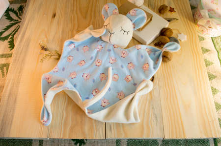 stitched stuffed toys for babies on a wood background