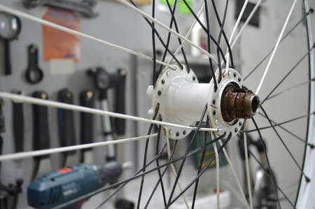 Disassembled bicycle bushing with spokes close up in the workshopの写真素材