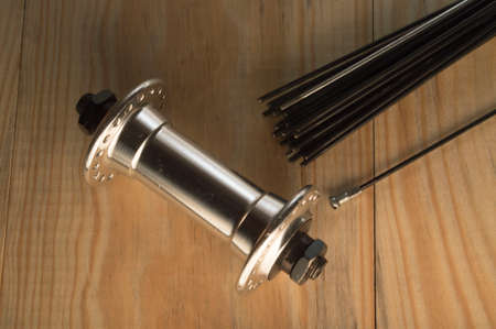 Disassembled bicycle bushing with spokes close up in the workshopの写真素材