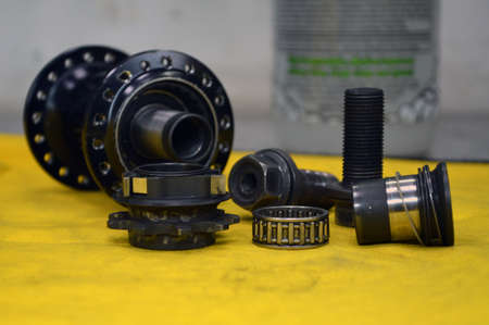 Disassembled bicycle bushing with spokes close up in the workshopの写真素材