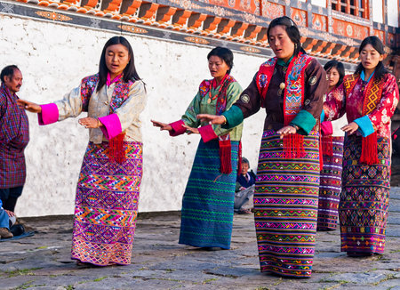 Women wearing kira dresses are dancing in a traditional festival in Bumthang - Bhutanのeditorial素材