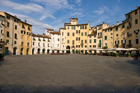 Piazza Anfiteatro in the old town of Lucca - Italy. The ring of buildings surrounding the square, follows the elliptical shape of the former Roman Amphitheater of Luccaのeditorial素材