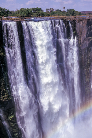 Rainbow over Victoria Falls - Zimbabwe. Photo taken from bellow the falls.の写真素材