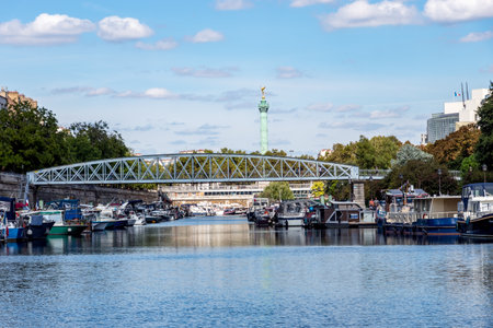 Paris, France - September 8, 2018: Boats docked on Canal Saint Martin with Bastille July column in backgroundのeditorial素材