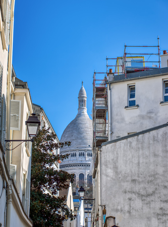 View of the dome of the Sacre Coeur from a narrow street of Montmartre - Paris, Franceの写真素材