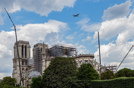 Paris, France - July 11 2019: French military aircrafts flying over Notre Dame de Paris while reinforcement work is in progress after the fire. This is a rehearsal fly for Bastille Day Parade.のeditorial素材