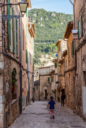 Valldemossa, Spain - October 20, 2018: Tourists walking in a narrow street in the old Valldemossa village - Mallorca, Spainのeditorial素材