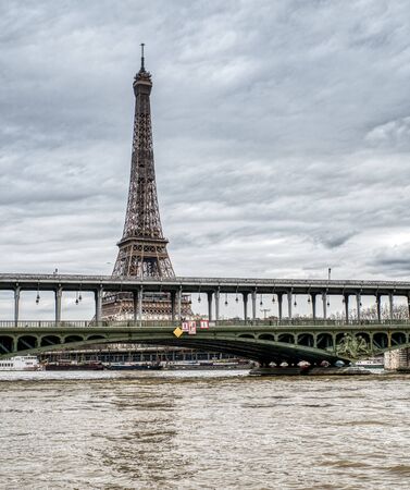 Eiffel Tower on a cloudy day with Bir-hakeim bridge in foreground - Paris, Franceの写真素材