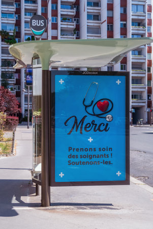 Paris, France - April 23 2020: Outdoor Bus stop billboard during Coronavirus Lockdown in Paris street with the message 'Thank you - Take care of the nursing staff ! Support them'のeditorial素材
