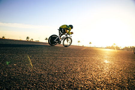 Cyclist riding on asphalt road at sunset. Sport and healthy lifestyle conceptの写真素材