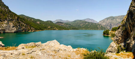 Reservoir among mountains with green clear waterの写真素材