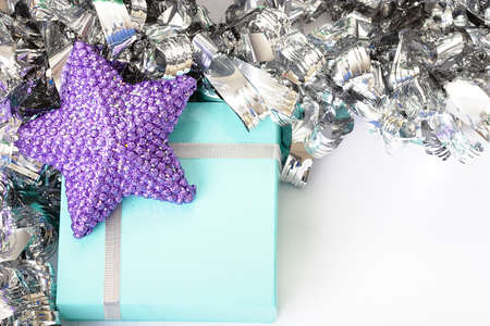 Purple star on top of a light blue gift boxの写真素材