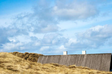 House roof hidden by sand dunesの写真素材