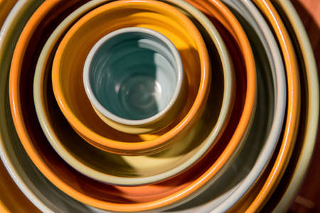 Hand crafted bowls stacked together. Nested bowls on the shelf.の写真素材
