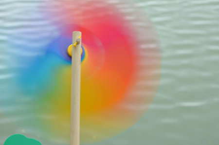 Spinning pinwheel against lake backgroundの写真素材