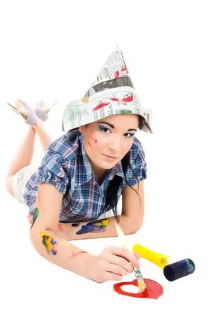 Pretty painter girl drawing red heart on white backgroundの写真素材